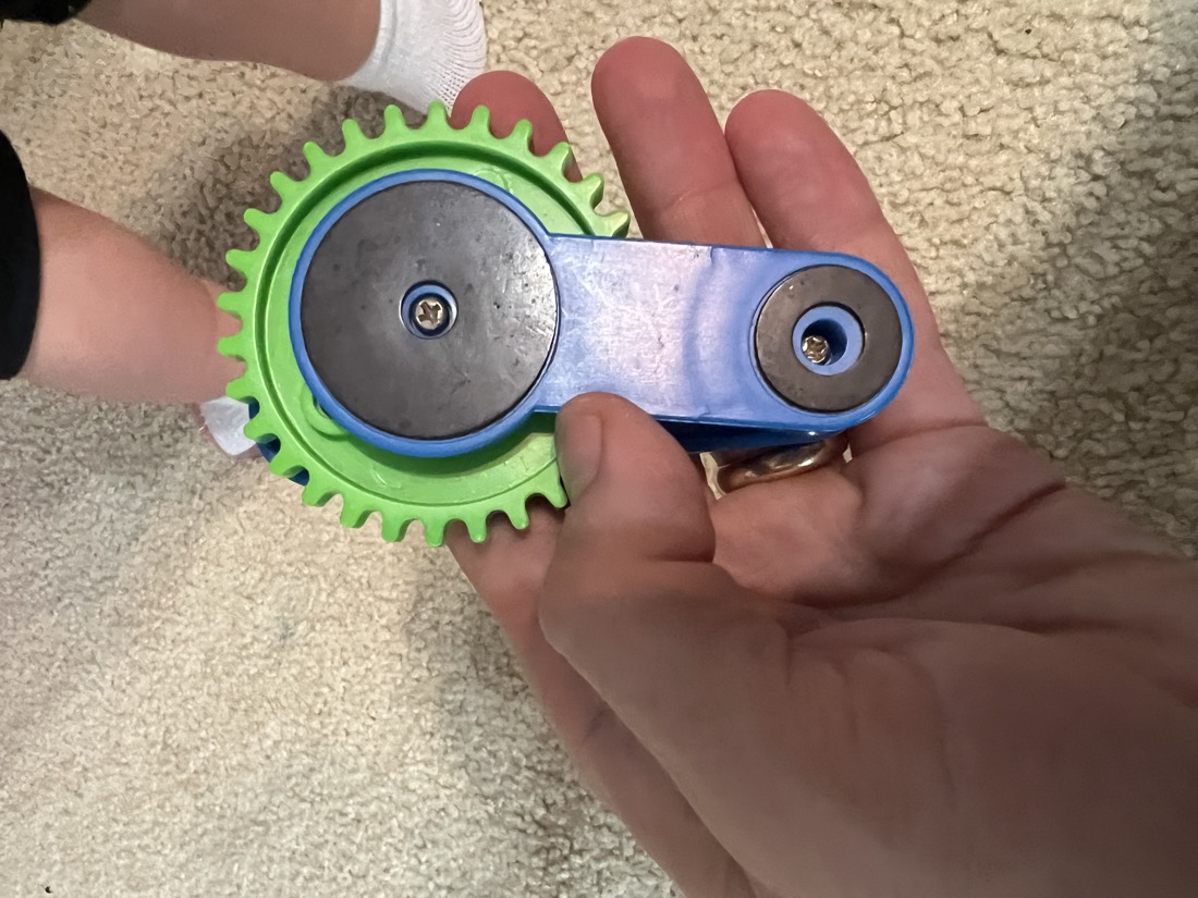 Back photo of the toy showing rear fastener disks and screws